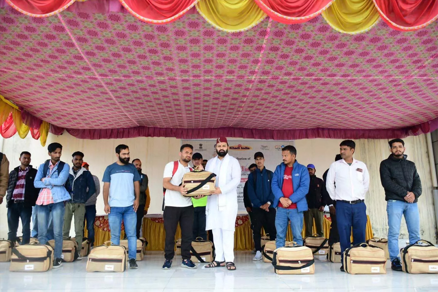 Distribution of machinery and toolkits to people under Village Industry Development Scheme